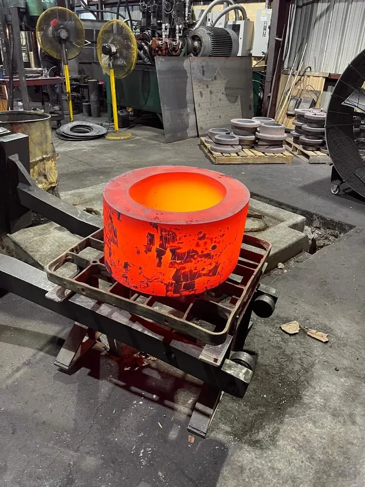 Hot forged steel ring on a cooling rack at MTS Forge