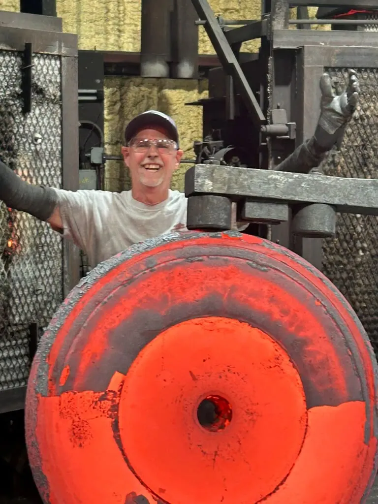 Experienced MTS Forge craftsman inspecting a freshly forged steel component