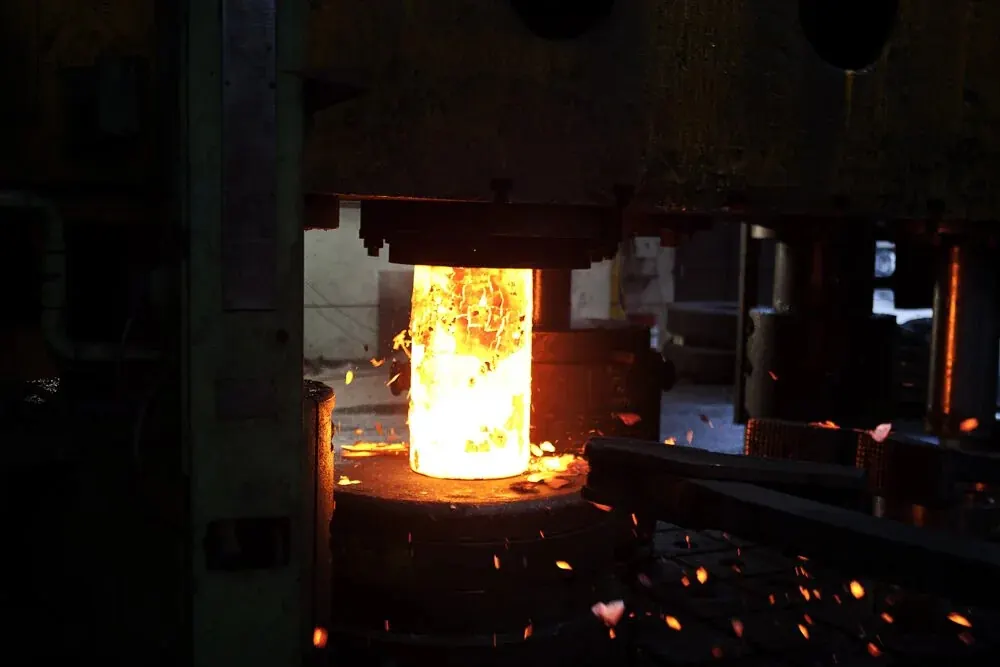 Closed-die forging impression dies pressing a hot steel part to a repeatable production shape