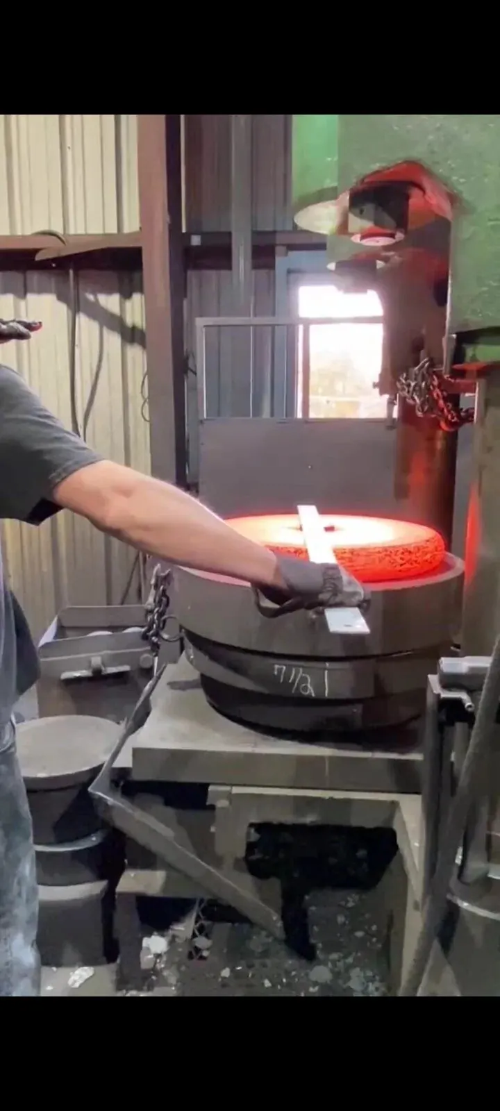 Steel plate being hot formed into a curved section at MTS Forge
